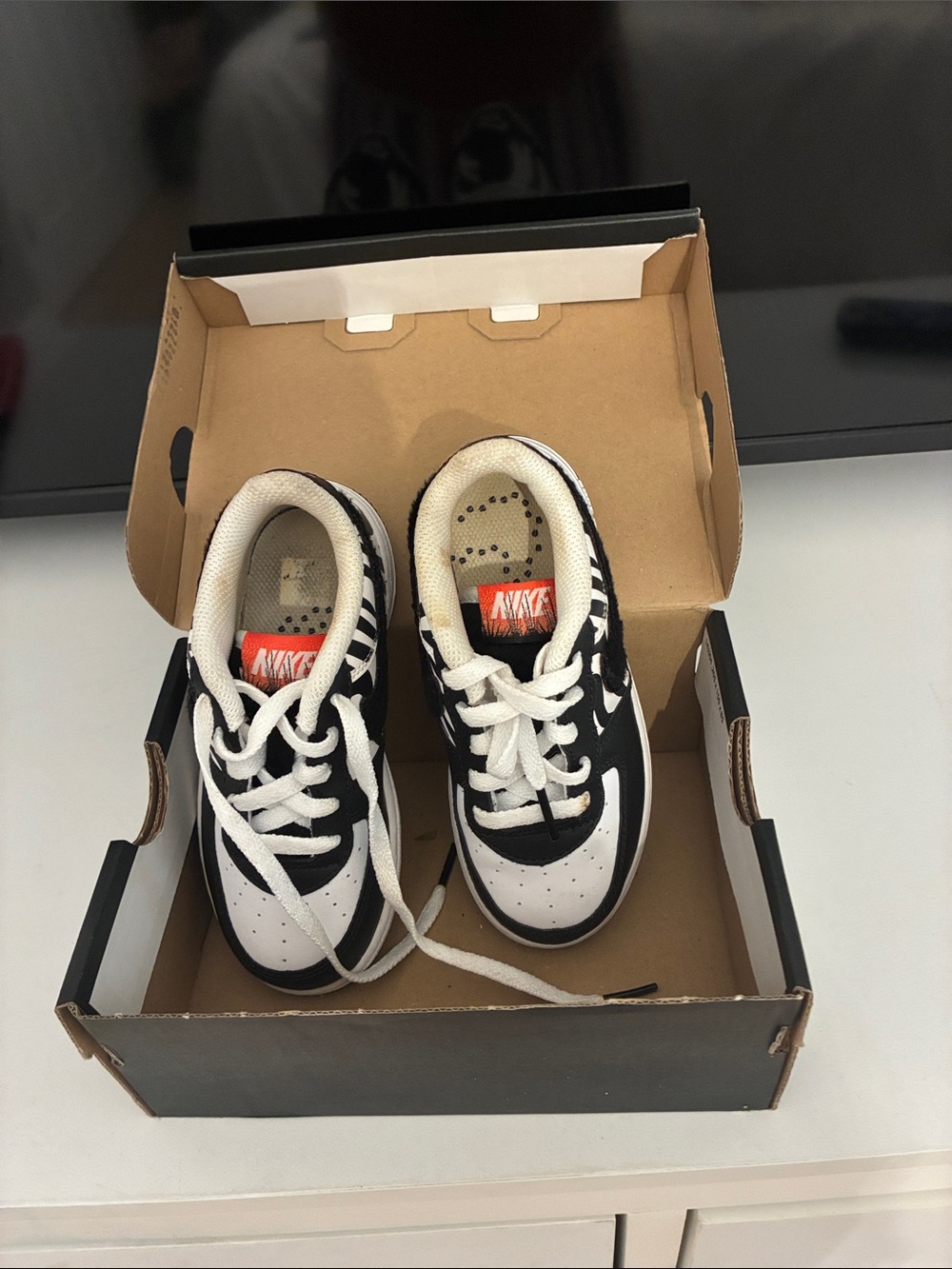 Nike Kids Black and White Sneakers with Orange Tongue Tag